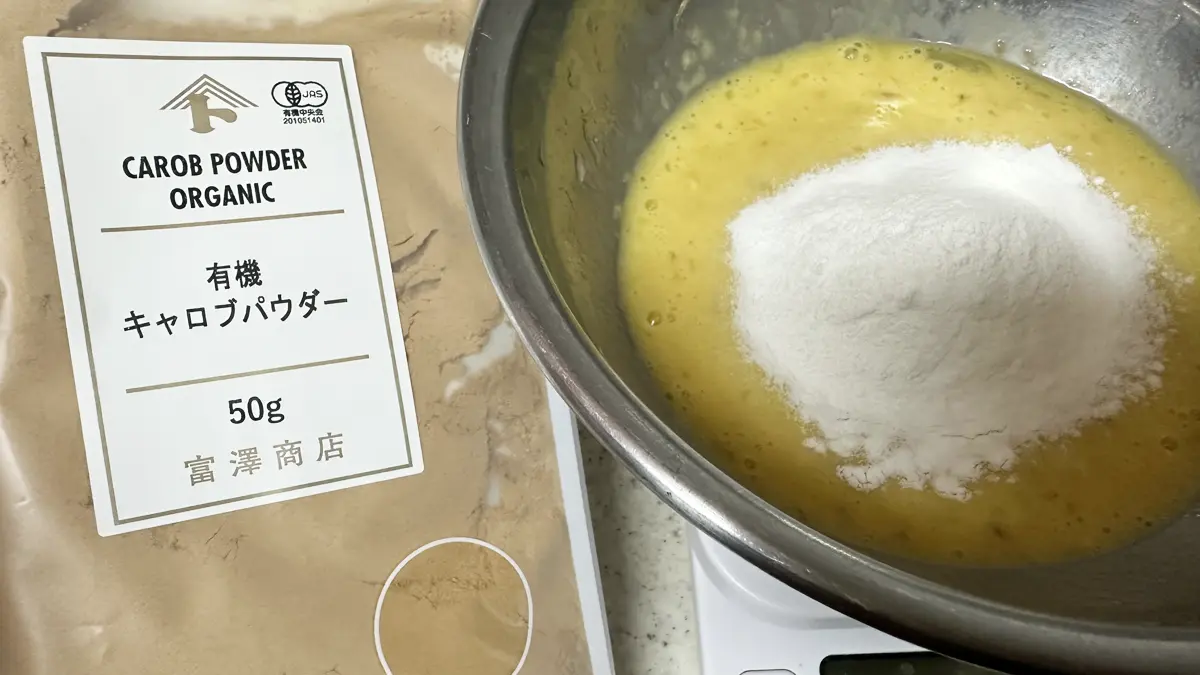 左側には富澤商店の有機キャロブパウダー、右側にはバナナと卵、豆乳、米粉が入ったボウル